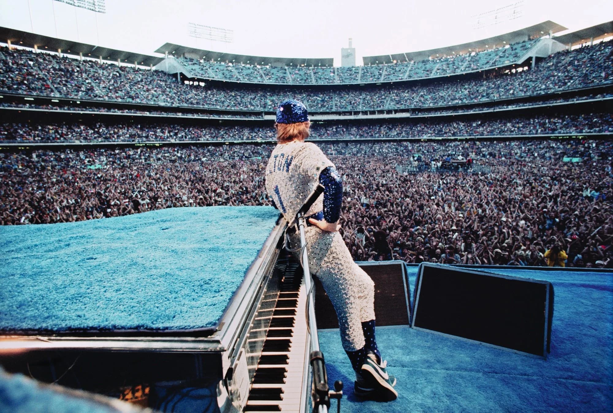 Elton John performing at a piano